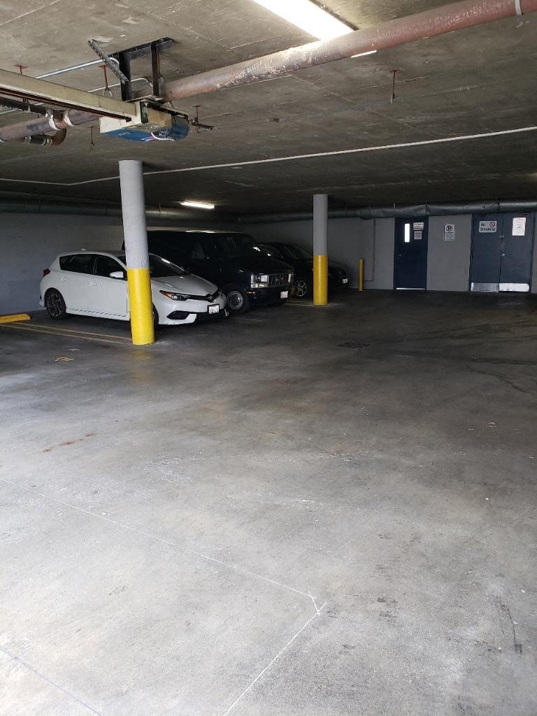 three cars parked in a parking garage